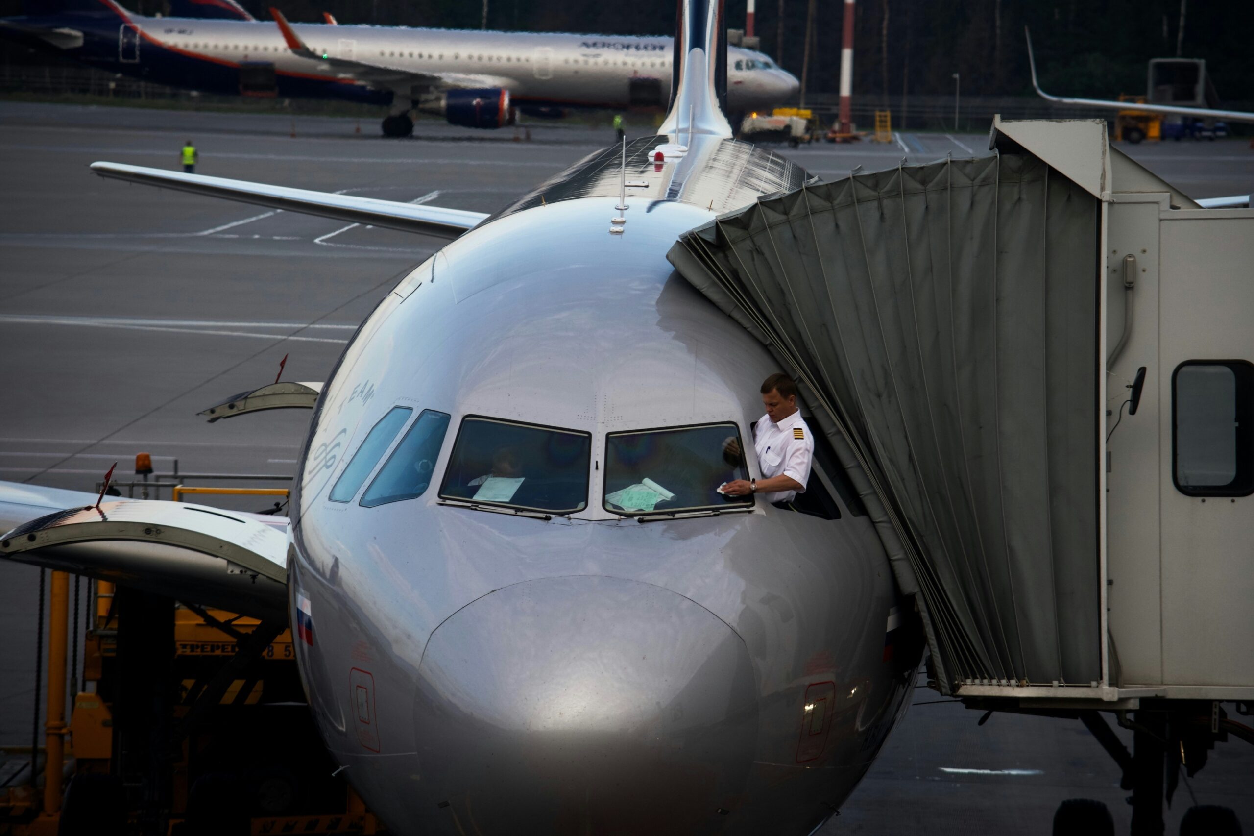 Airline staff assisting passengers with paperwork