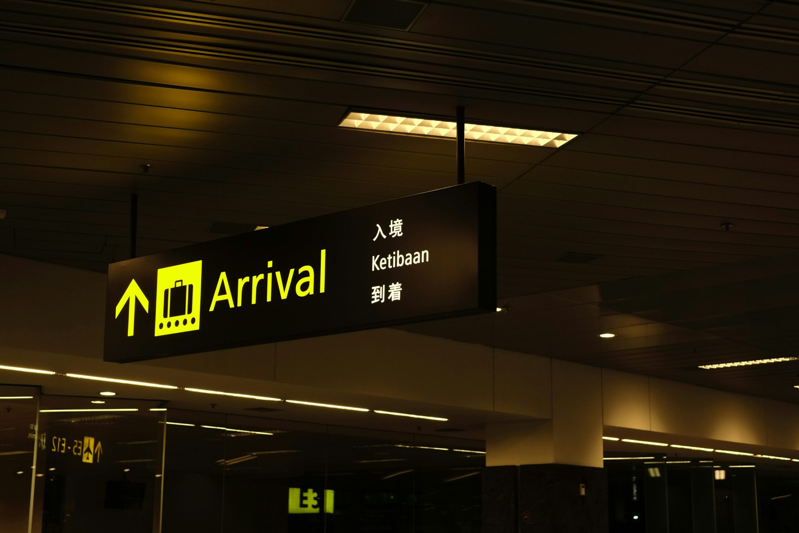 A traveler looking stressed at an airport baggage carousel