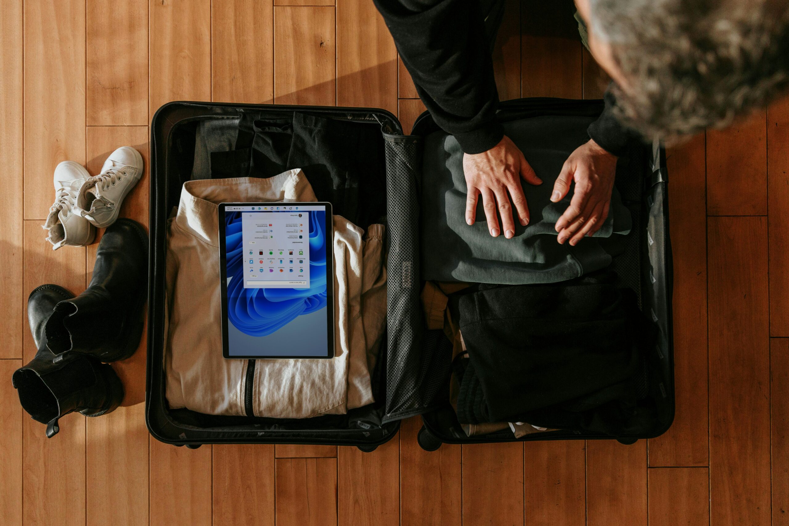 A smiling traveler holding their newly-replaced laptop after filing a claim successfully
