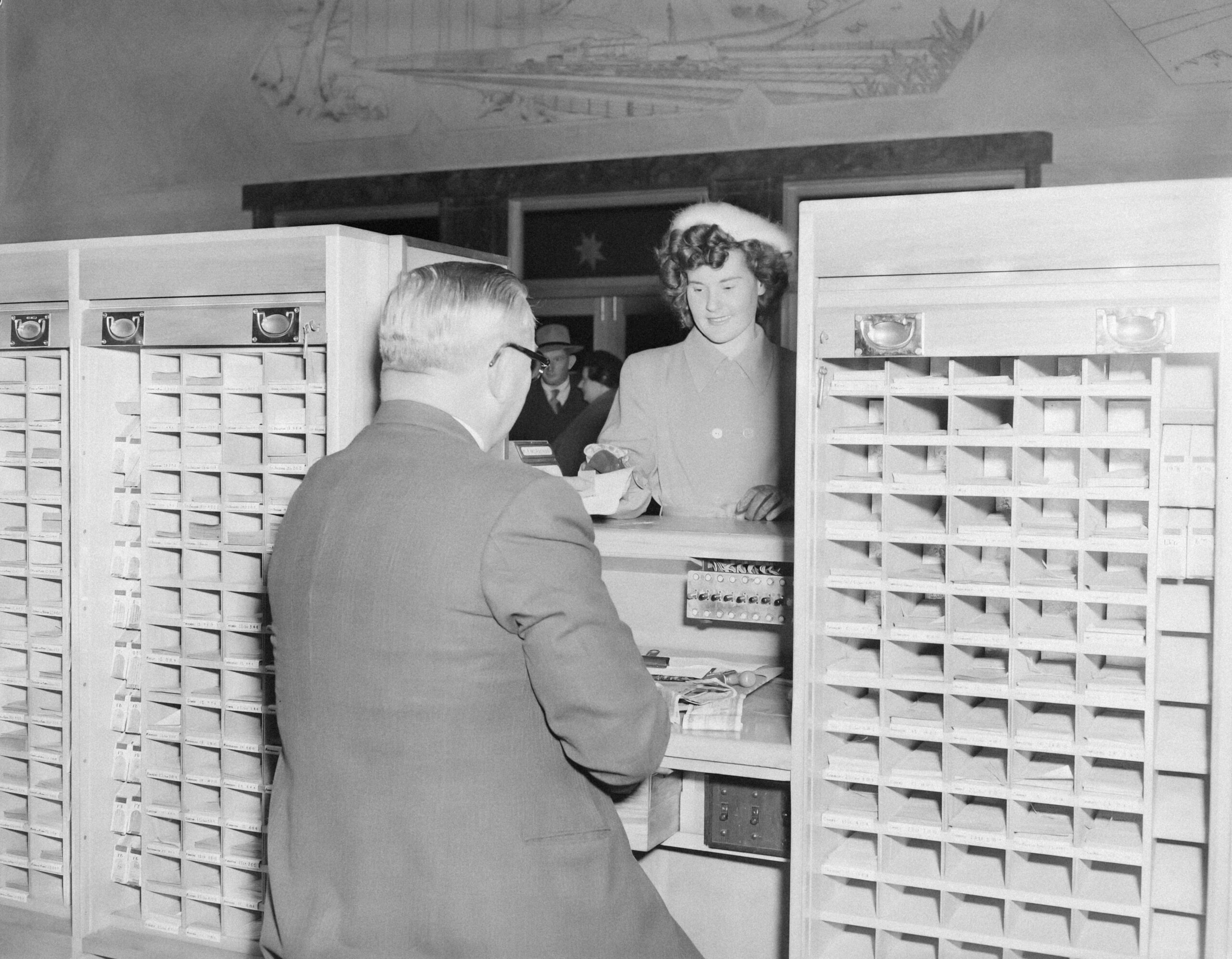 Woman holding a check labeled 'Claim Approved'
