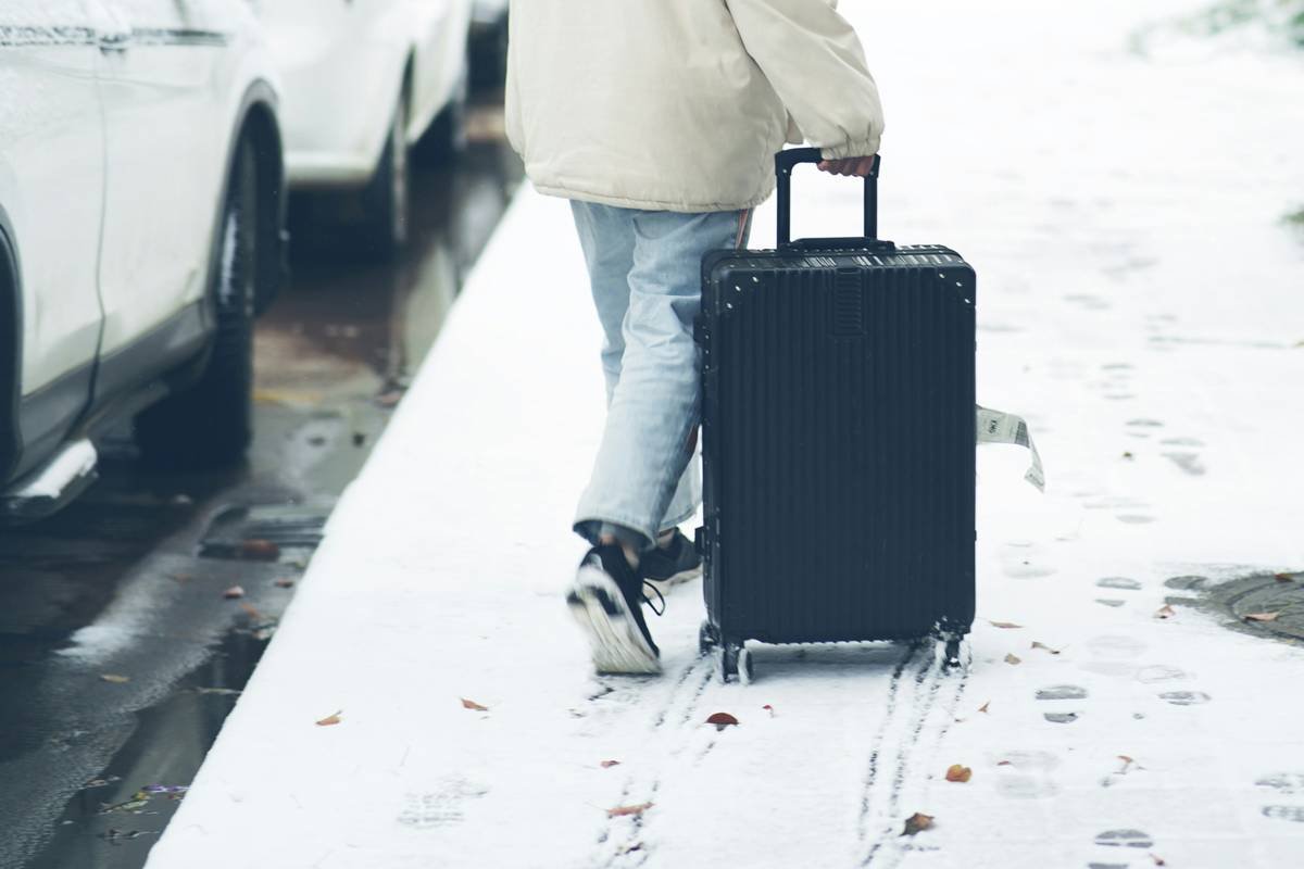 A woman happily unpacking newly purchased items as part of a successful baggage claim process.