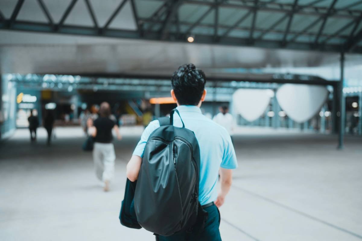 Photo of happy traveler holding new backpack