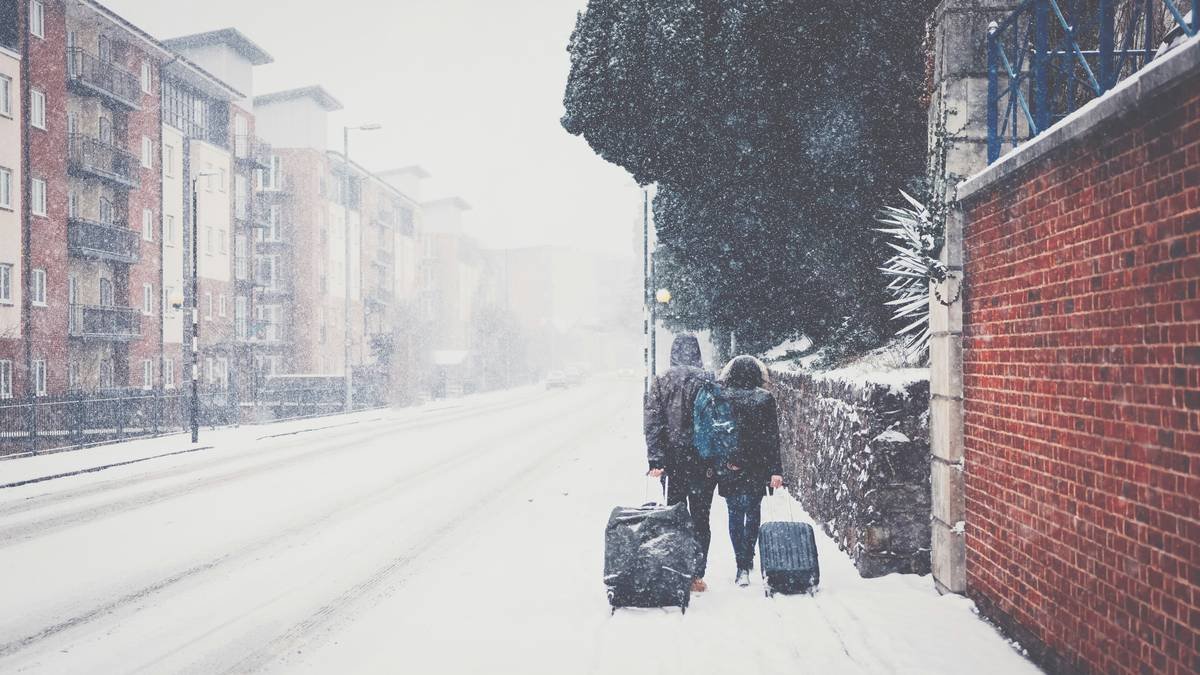 A pile of winter sports gear including skis, boots, and helmets
